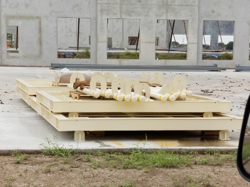 Truck scale components staged on a prepared concrete foundation prior to scale installation at an industrial site in El Paso, TX