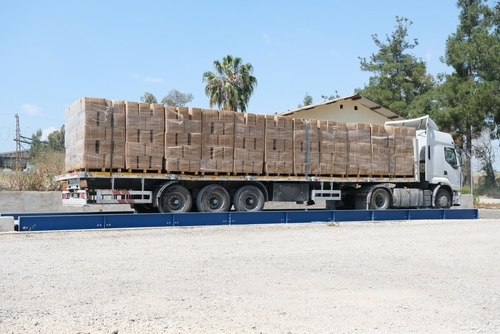 Heavy-duty truck scale weighing a fully loaded flatbed, showcasing reliable industrial scale equipment used for commercial operations in El Paso, TX